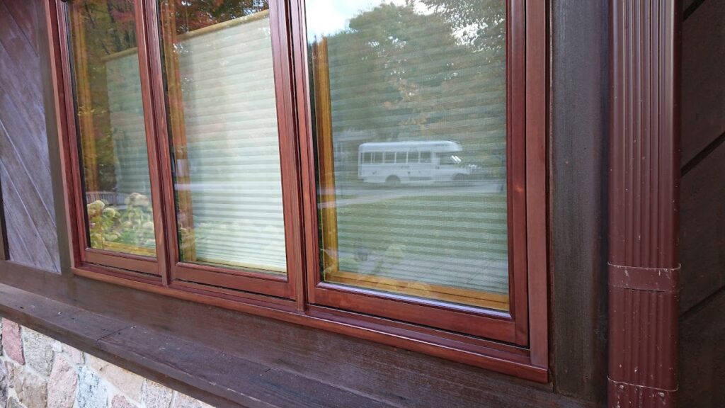 Freshly painted exterior wood window frame and sill on a Toronto-area home