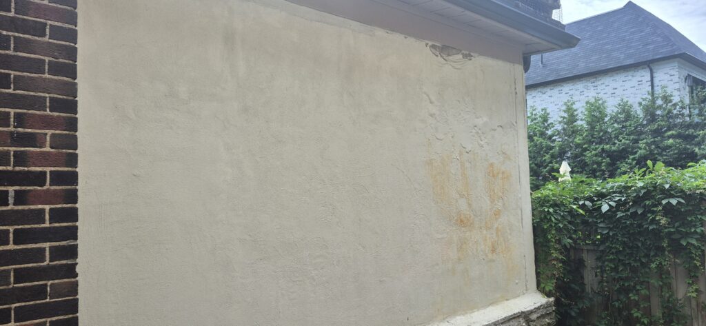 Damaged exterior cement wall before repair in a Toronto-area home