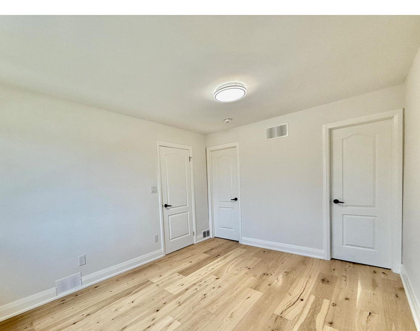 Finished interior doors, trim, and baseboards in a Toronto-area renovation